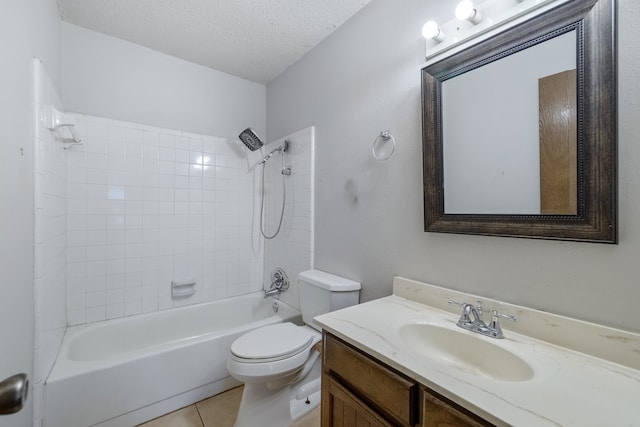 full bathroom featuring tiled shower / bath, a textured ceiling, toilet, vanity, and tile patterned flooring