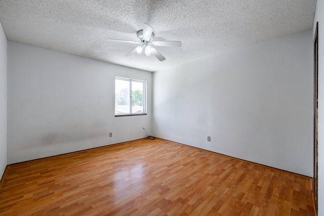 empty room with light hardwood / wood-style flooring, a textured ceiling, and ceiling fan