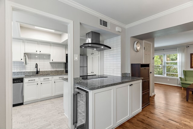 kitchen featuring sink, white cabinetry, dark stone countertops, stainless steel appliances, and exhaust hood