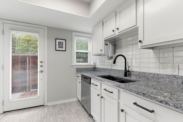 kitchen with dishwasher, white cabinetry, a wealth of natural light, and sink