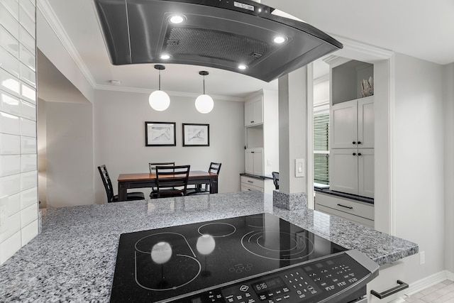 kitchen featuring white cabinetry, light stone countertops, black stove, hanging light fixtures, and ornamental molding