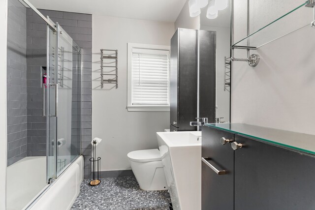 full bathroom with vanity, combined bath / shower with glass door, and toilet