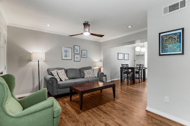 living room featuring ceiling fan, dark hardwood / wood-style floors, and ornamental molding