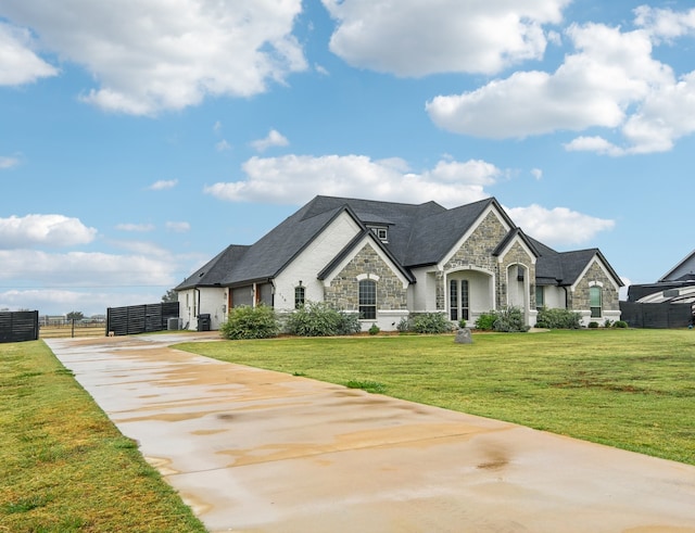 french provincial home featuring a front yard