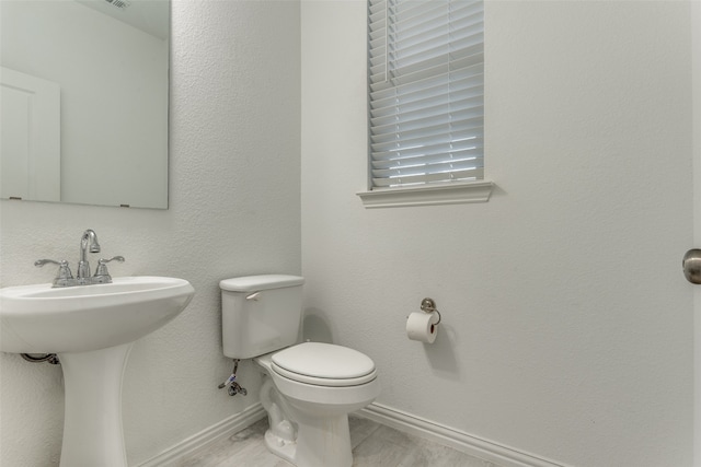 bathroom with hardwood / wood-style floors and toilet