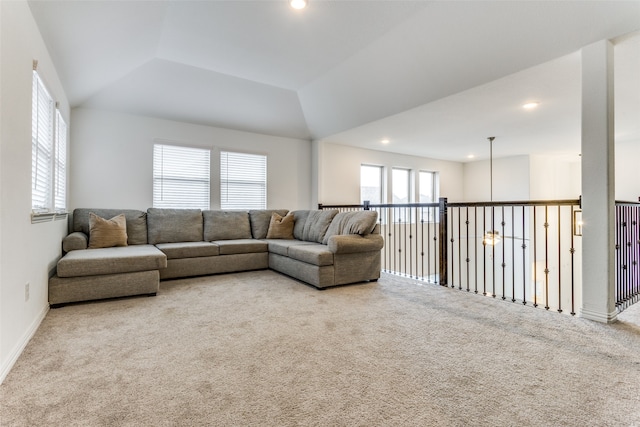 living room featuring lofted ceiling, light colored carpet, and ceiling fan