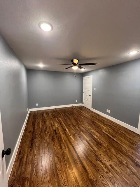 empty room with ceiling fan and wood-type flooring