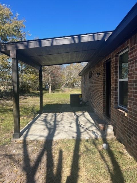 exterior space featuring a carport and a lawn