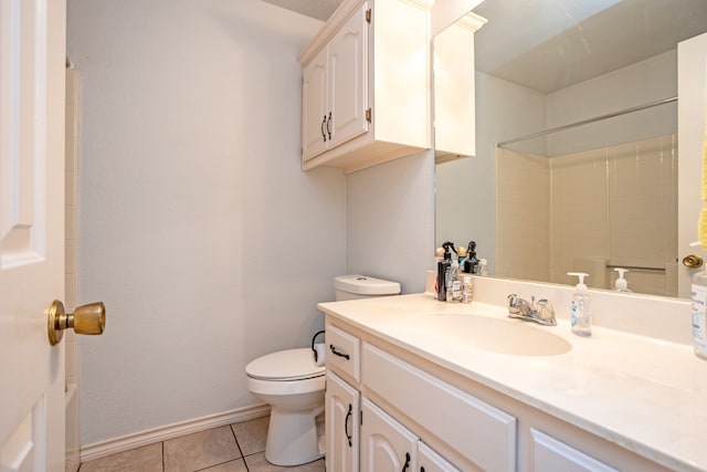 bathroom featuring a shower, tile patterned flooring, vanity, and toilet