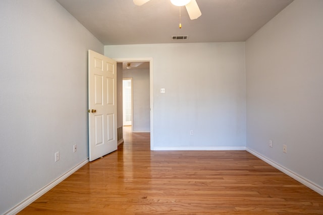 unfurnished room with ceiling fan and light wood-type flooring