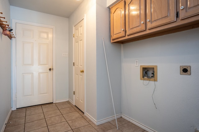 washroom with cabinets, light tile patterned floors, washer hookup, and hookup for an electric dryer