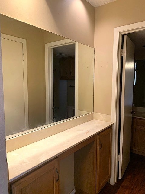 bathroom featuring vanity, hardwood / wood-style floors, and a textured ceiling