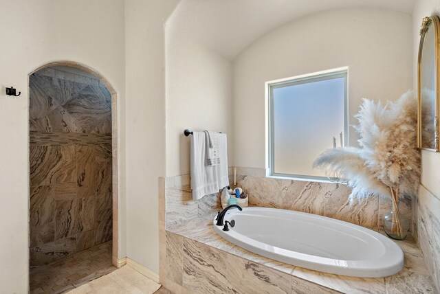 bathroom with tile patterned floors and separate shower and tub