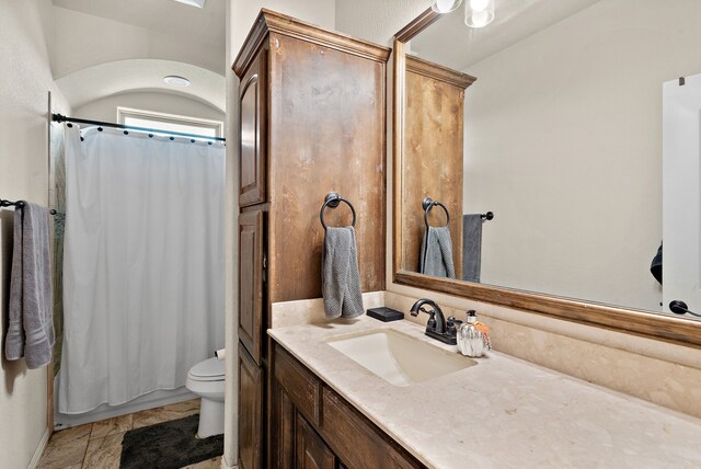 bathroom with tile patterned flooring, vanity, and toilet