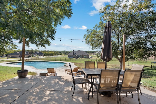 view of swimming pool featuring a patio area and a lawn