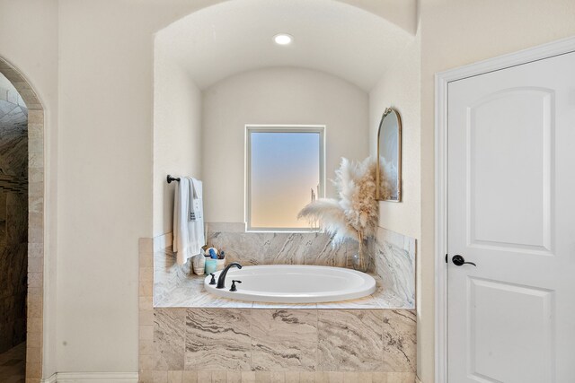 bathroom featuring separate shower and tub