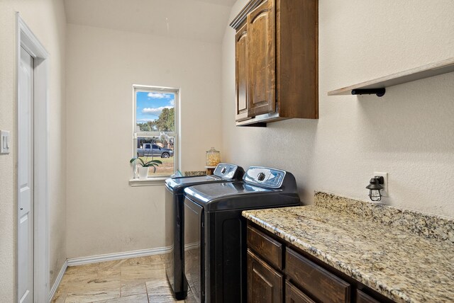 washroom featuring cabinets and independent washer and dryer