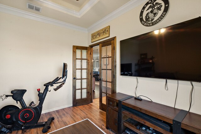 workout room with french doors, hardwood / wood-style flooring, and ornamental molding