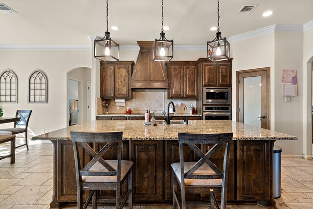 kitchen with stainless steel appliances, a kitchen breakfast bar, and a large island