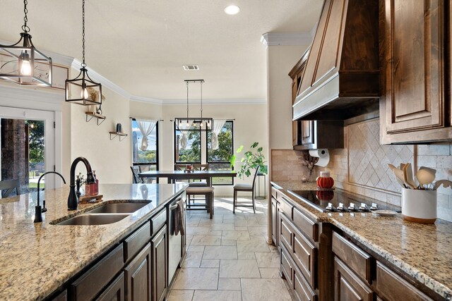 kitchen featuring a healthy amount of sunlight, premium range hood, black electric stovetop, and ornamental molding