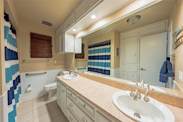 bathroom with tile patterned flooring, vanity, and toilet