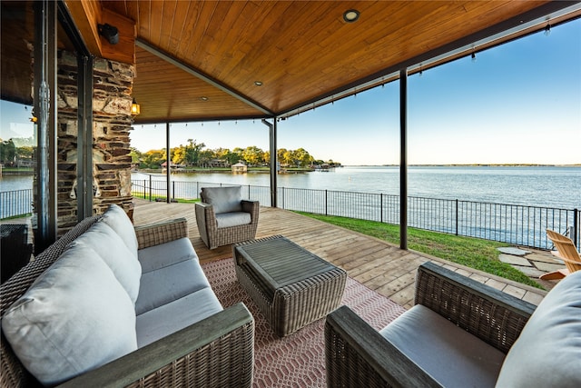 exterior space with a water view and an outdoor living space