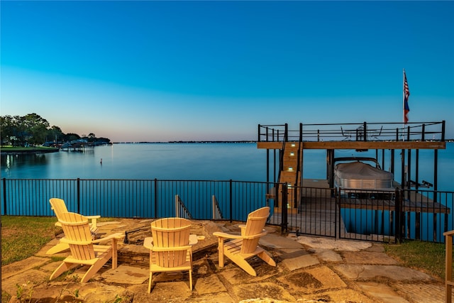 view of patio / terrace with a fire pit and a water view