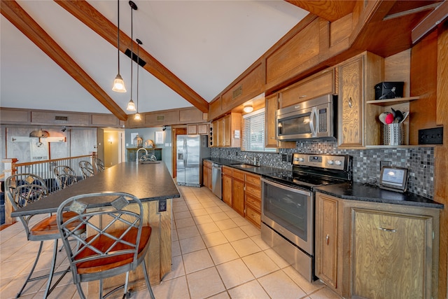 kitchen featuring stainless steel appliances, sink, light tile patterned floors, backsplash, and pendant lighting