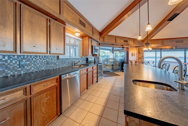 kitchen with stainless steel appliances, sink, ceiling fan, backsplash, and lofted ceiling with beams