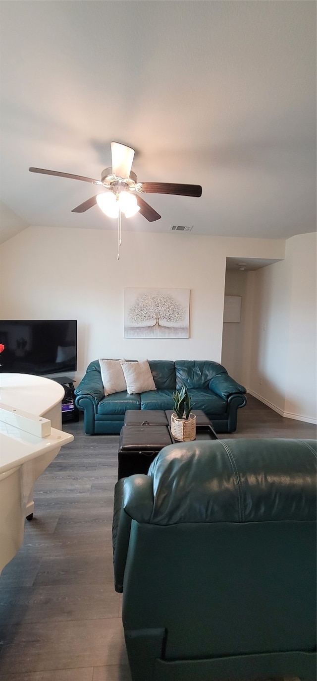 living room with lofted ceiling, hardwood / wood-style flooring, and ceiling fan