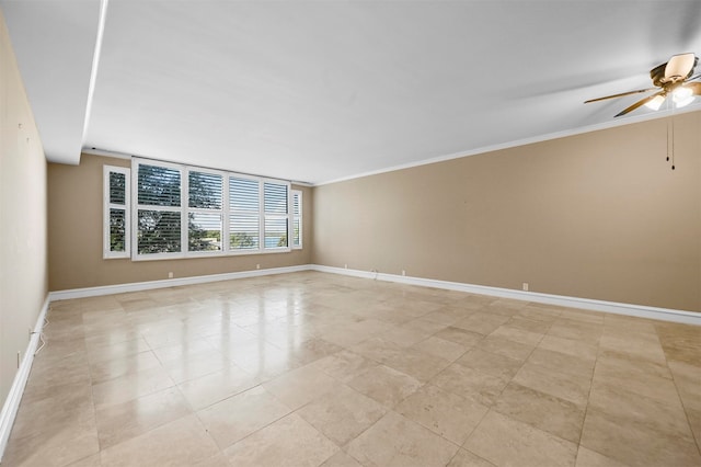 unfurnished room featuring ornamental molding, a ceiling fan, and baseboards