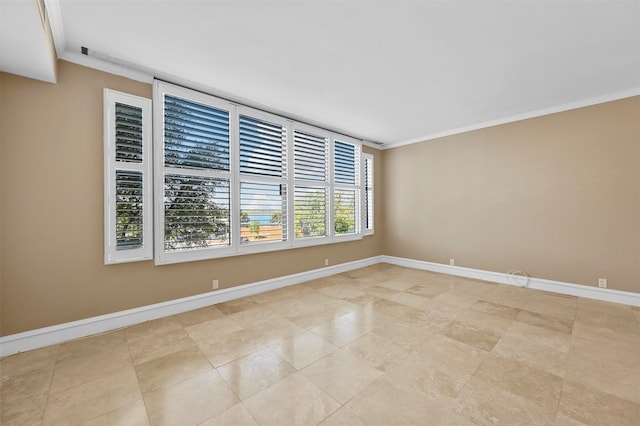 spare room featuring baseboards and ornamental molding