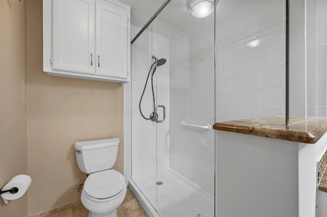 full bathroom featuring toilet, tile patterned flooring, and a tile shower