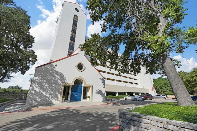 view of building exterior featuring uncovered parking