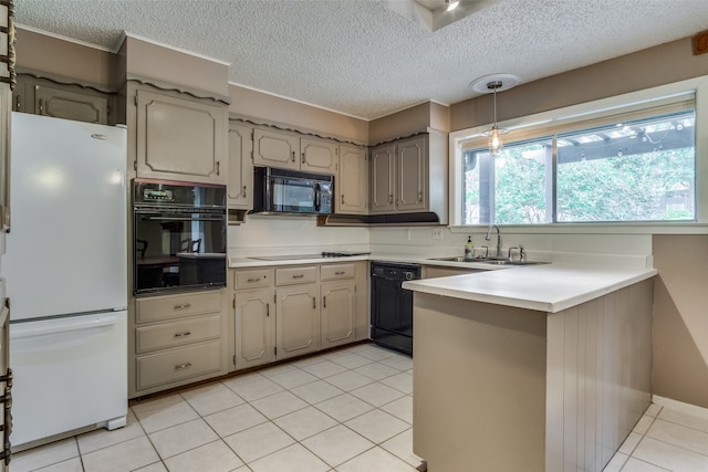 kitchen featuring kitchen peninsula, sink, black appliances, light tile patterned floors, and a textured ceiling