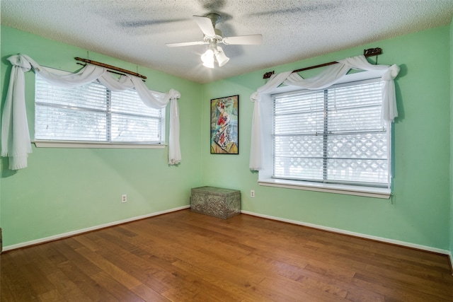 spare room with hardwood / wood-style floors, a textured ceiling, and ceiling fan