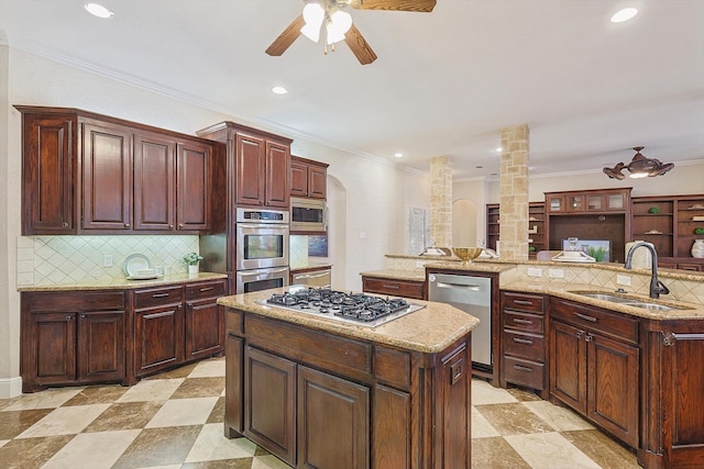 kitchen with a large island, decorative backsplash, decorative columns, sink, and stainless steel appliances