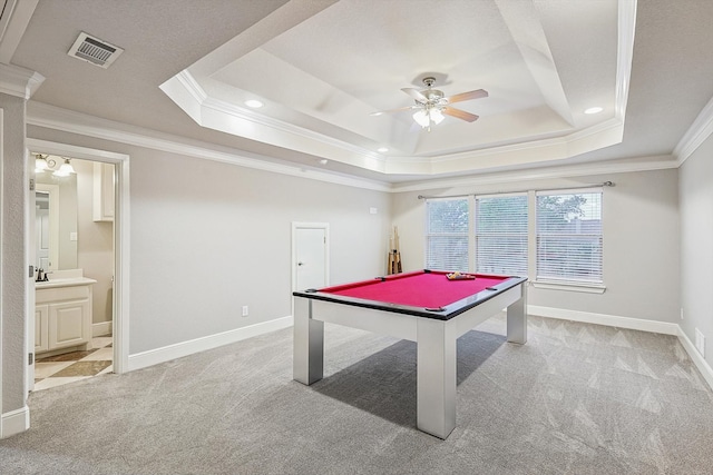 game room with crown molding, light colored carpet, and a tray ceiling