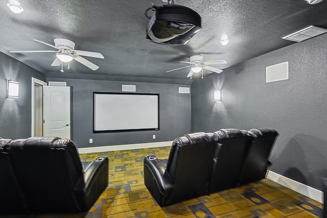 cinema with a textured ceiling and ceiling fan