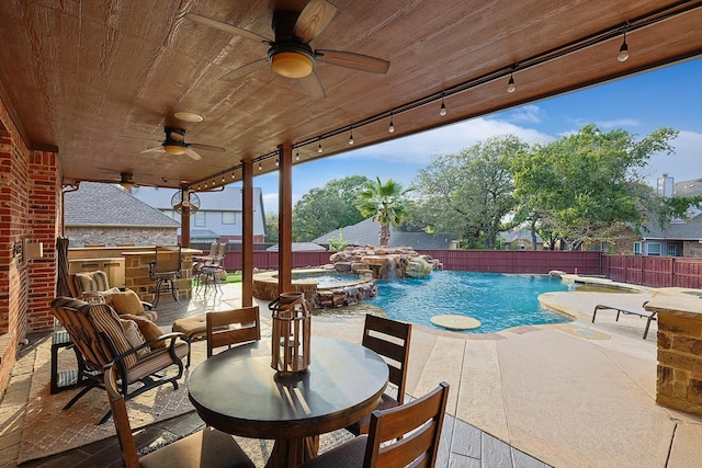 view of pool featuring a patio, pool water feature, an in ground hot tub, and ceiling fan