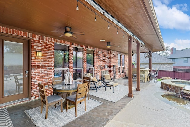 view of patio featuring an outdoor hot tub and ceiling fan