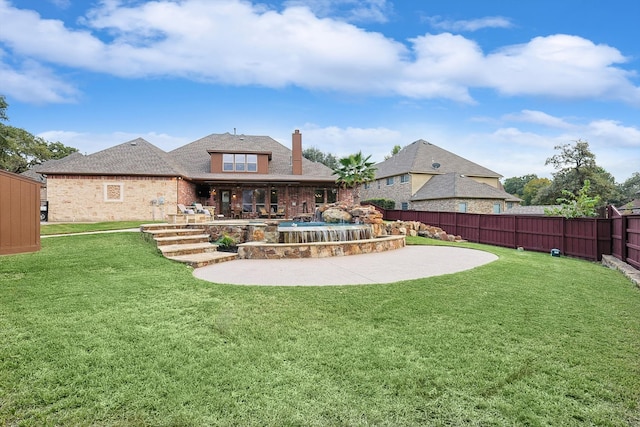 rear view of property featuring a patio and a yard