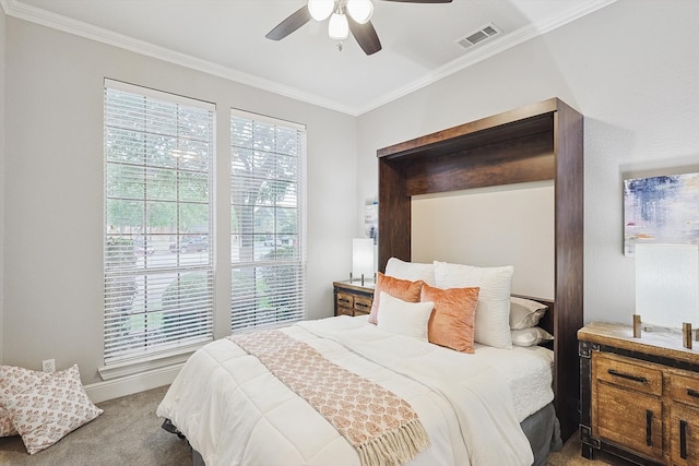 carpeted bedroom with multiple windows, ornamental molding, and ceiling fan