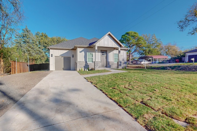 view of front of home featuring a garage and a front lawn