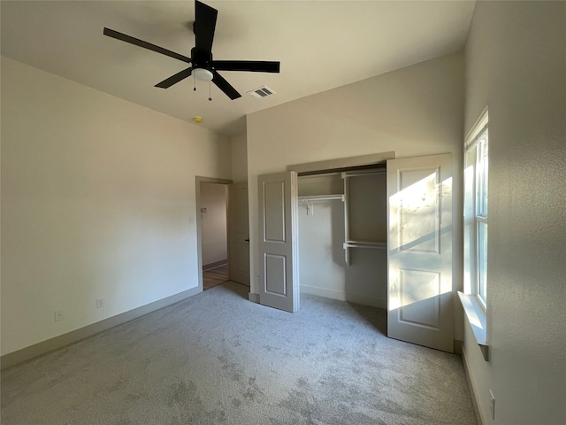 unfurnished bedroom with a closet, ceiling fan, and light colored carpet