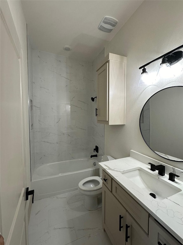 full bathroom featuring tiled shower / bath, vanity, and toilet