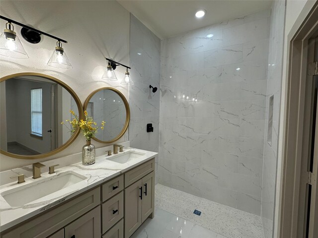 bathroom with vanity and a tile shower