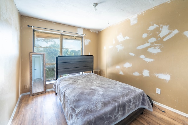 bedroom with hardwood / wood-style floors