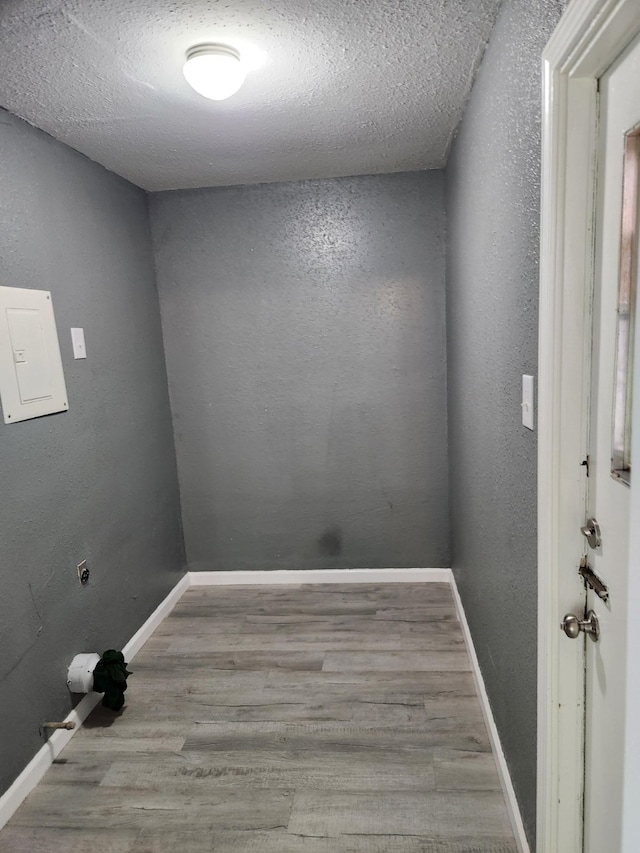 empty room featuring a textured ceiling and light wood-type flooring