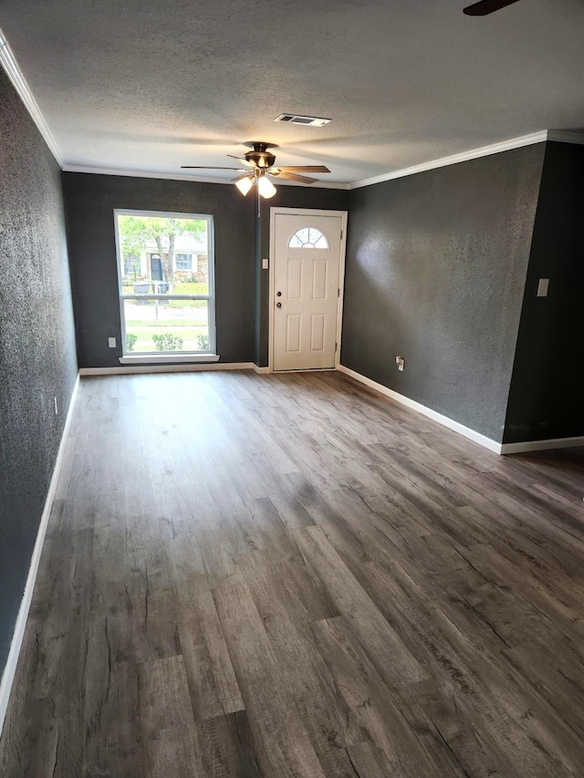 unfurnished living room with hardwood / wood-style floors, crown molding, a textured ceiling, and ceiling fan